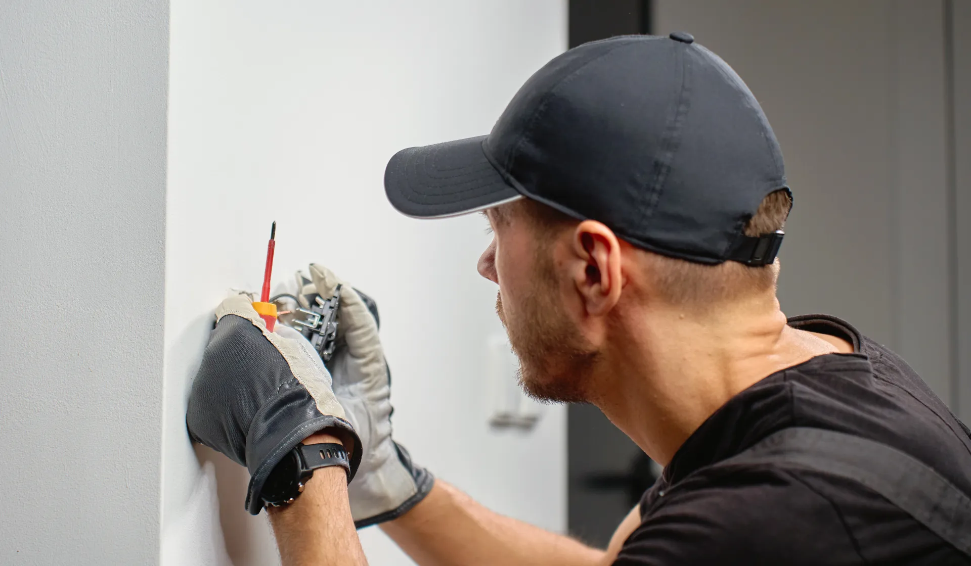 An electrician reviewing their phone with few incoming calls, illustrating the challenge of generating consistent leads without a proper digital marketing strategy